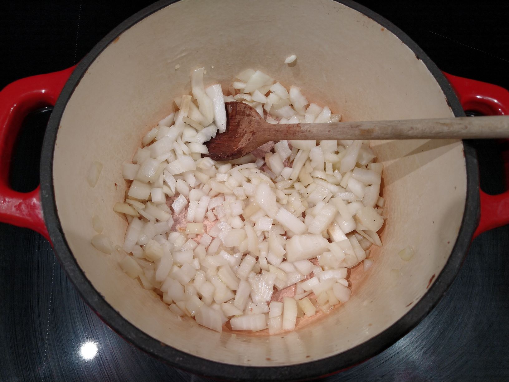Adding the onions to the pot.
